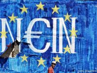 
	Țara care a fost pe punctul de a îngropa euro rămâne o problemă în UE. A primit ajutor financiar de urgență mai mare decât întregul PIB al Danemarcei
